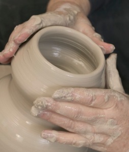 Hands Working on Ceramic Piece